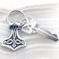 A key chain with a thor symbol on it.