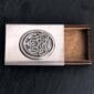 A silver business card holder in a wooden box.