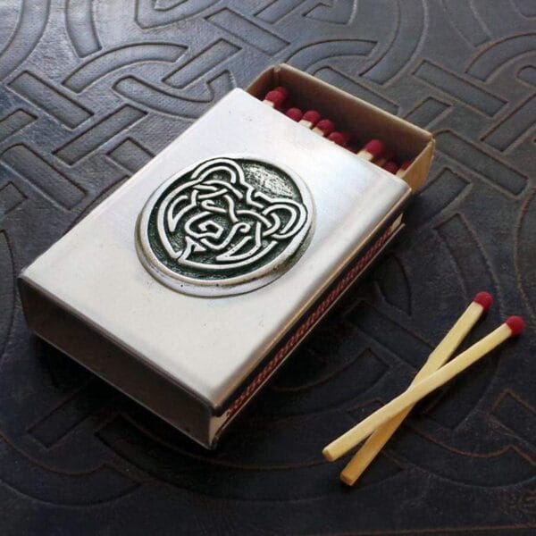A matchbox with a celtic design on it.