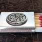 A matchbox with a celtic design on it.