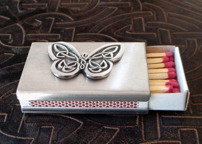 A matchbox with a butterfly on it. A matchbox with a butterfly on it.
