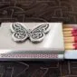 A matchbox with a butterfly on it.