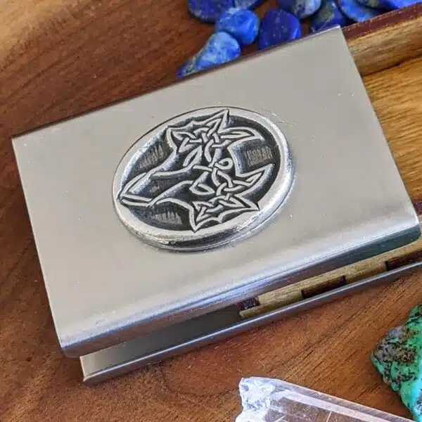 A silver box with stones and crystals on it. A silver box with stones and crystals on it.