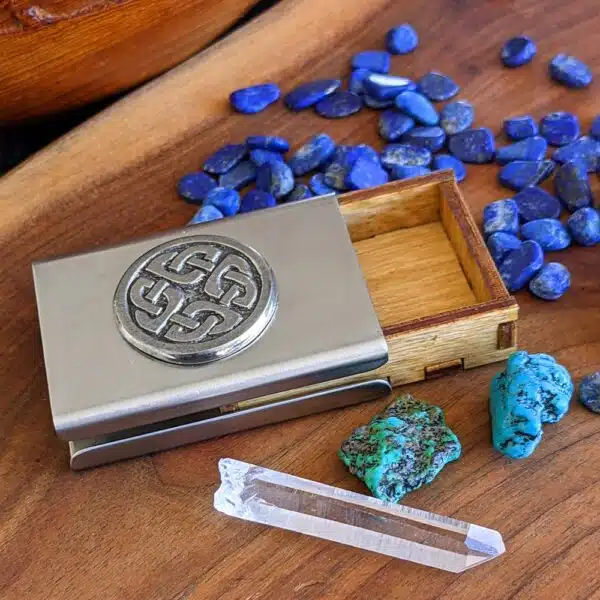 A metal box with stones and crystals next to it.