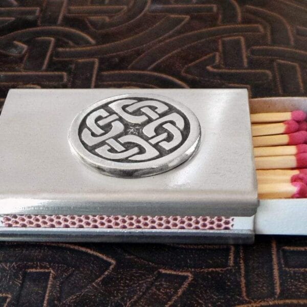 A matchbox with a celtic design on it.