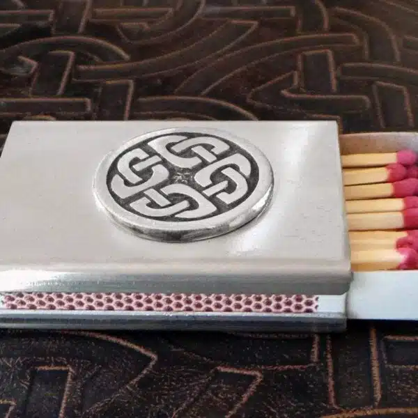 A matchbox with a celtic design on it.