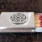 A matchbox with a celtic design on it.