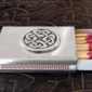 A matchbox with a celtic design on it.