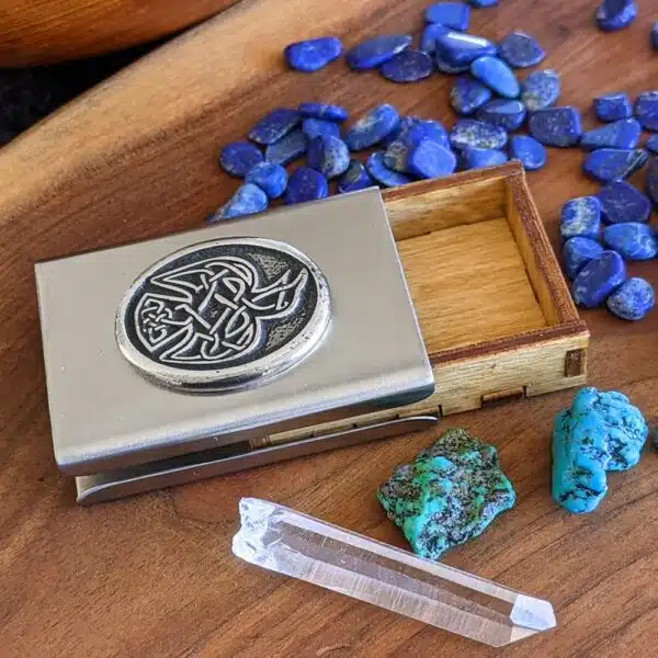 A business card holder with a blue stone and crystals.