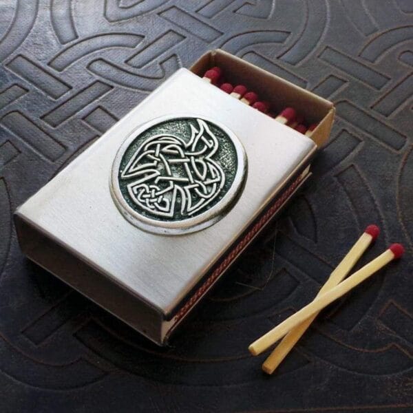 A matchbox with a celtic design on it.