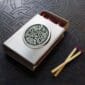 A matchbox with a celtic design on it.