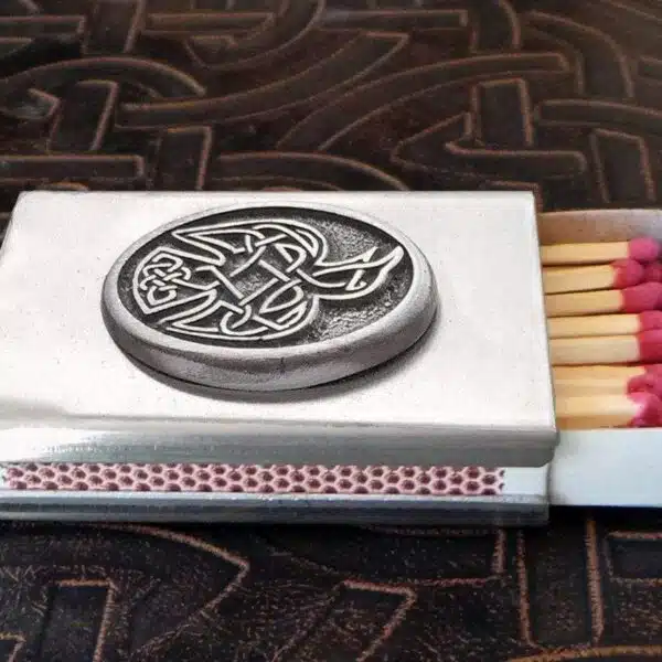 A matchbox with a celtic design on it.