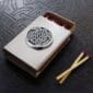A matchbox with a celtic design on it.