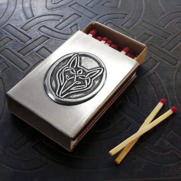 A matchbox with a wolf emblem on it.