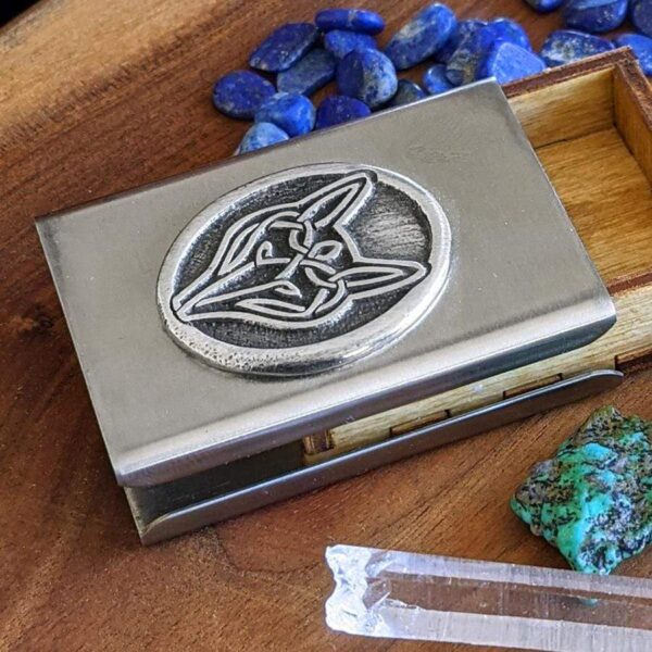 A business card holder with crystals and a fox on it.