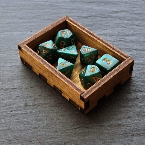 A set of green dice in a wooden box.