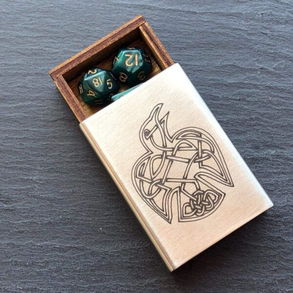 A wooden box with a set of dice in it.