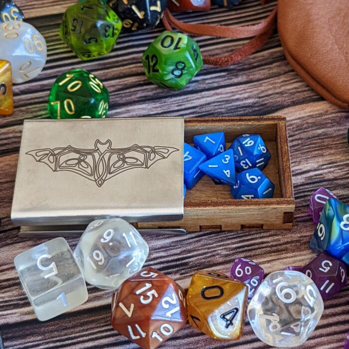 A set of dice and a bag on a table.