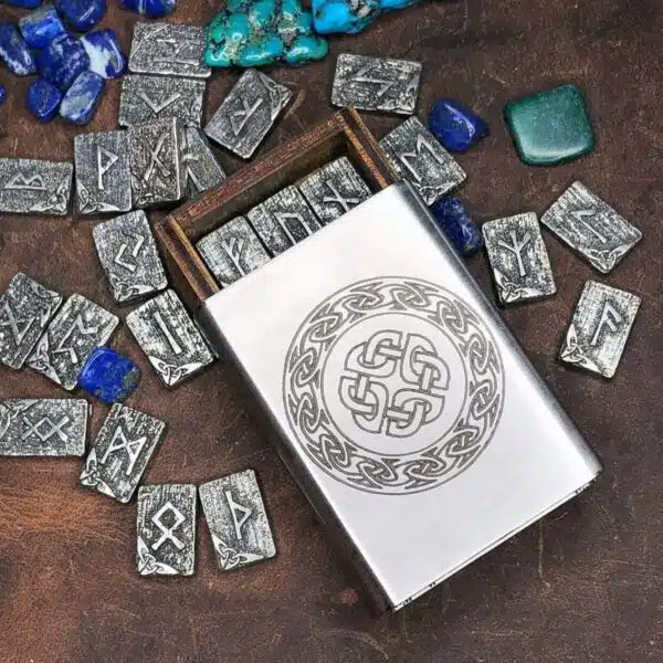 A metal box with stones and a celtic design on it.