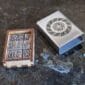 A wooden box with a viking symbol on it.
