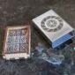 A wooden box with a viking symbol on it.