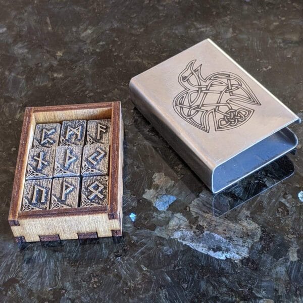 A wooden box with viking symbols on it.