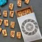 A wooden box with a set of wooden dominoes.