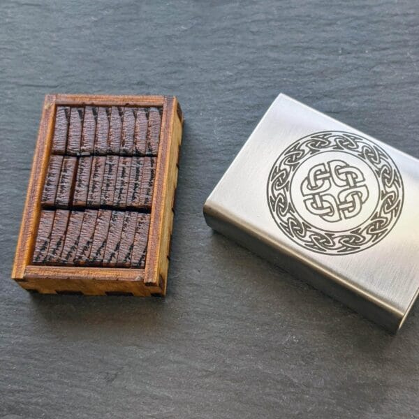 A wooden box with a celtic design on it.