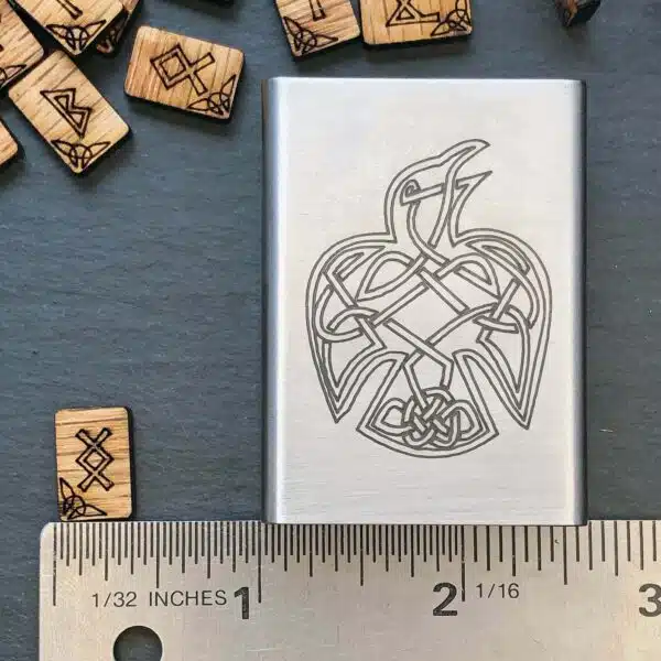 A wooden lighter with a celtic eagle design on it. A wooden lighter with a celtic eagle design on it.