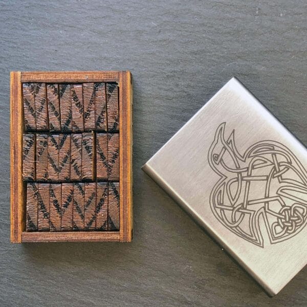 A wooden lighter with a design on it.