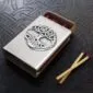 A matchbox with a celtic design on it.
