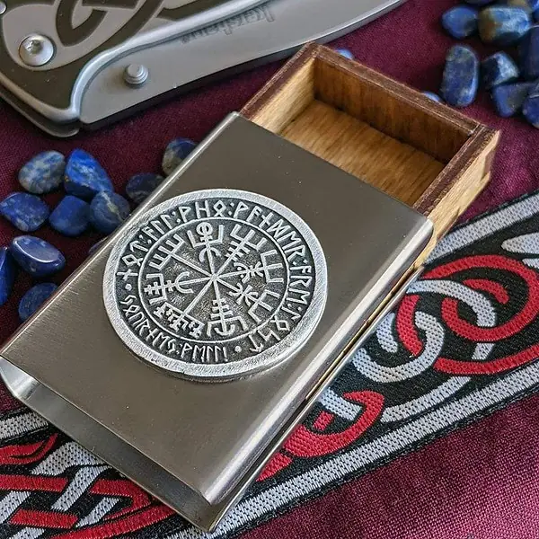 A wooden box with a viking symbol on it.