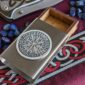 A wooden box with a viking symbol on it.