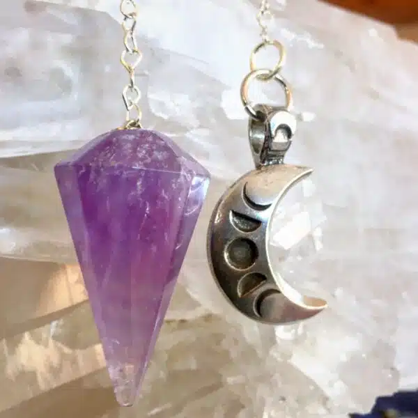 A purple amethyst wand and a silver crescent pendant.