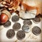 A group of small silver coins with the words start small.