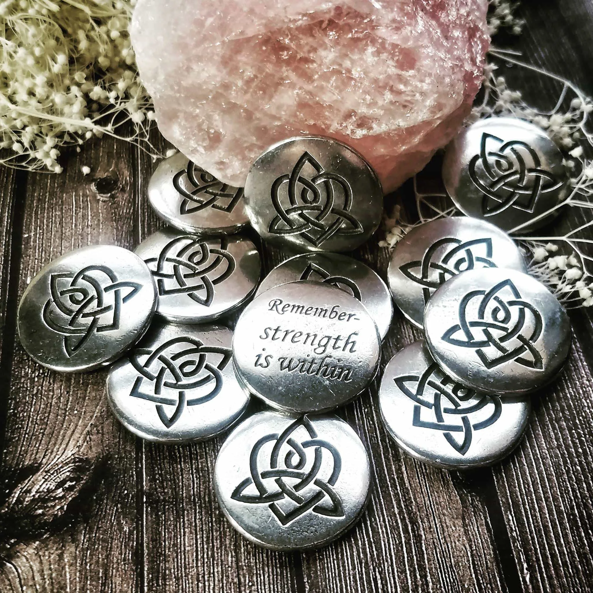 A group of silver buttons with a rose on them.