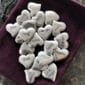 A group of silver heart shaped charms in a pouch.
