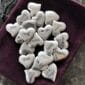 A group of silver heart shaped charms in a pouch.