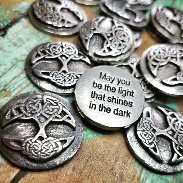 A selection of pewter charms featuring a Tree of Life design, including Irish blessings.