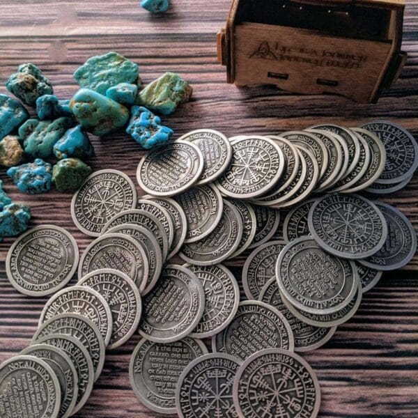 A pile of coins and stones on a wooden table.