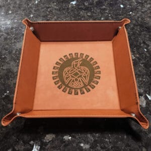 A leather tray with an eagle design on it.