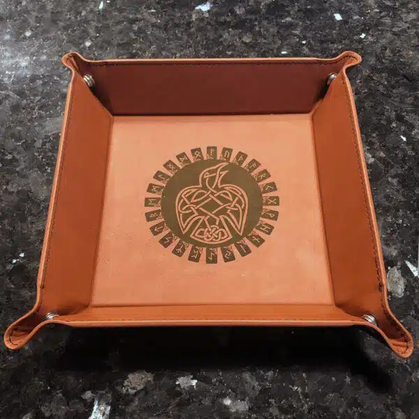 A leather tray with an eagle design on it.