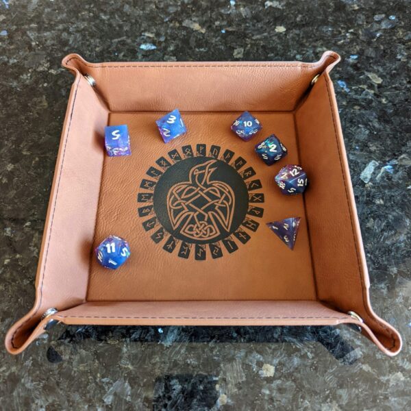A leather dice tray with dice in it.