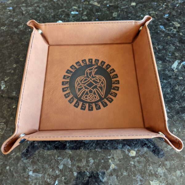 A leather tray with an eagle design on it.