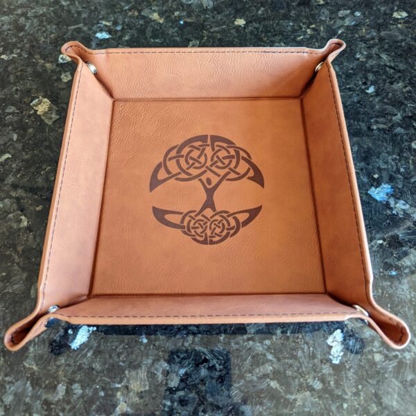 A leather tray with a celtic design on it.