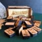 A wooden box with a set of wooden pieces in it.