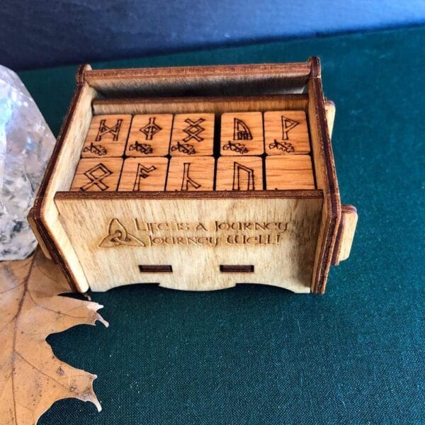 A wooden box with a set of dice on it.