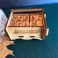 A wooden box with a set of dice on it.