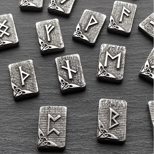 Viking symbols in silver on a black surface.