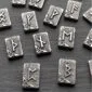 Viking symbols in silver on a black surface.